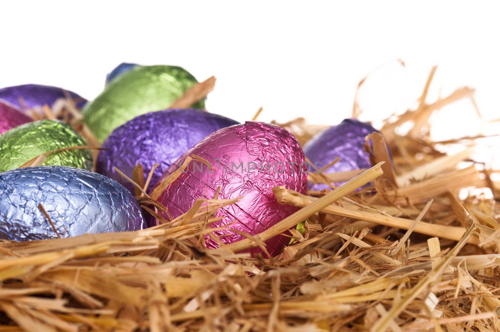 Straw nest with chocolate Easter eggs by 3523Studio