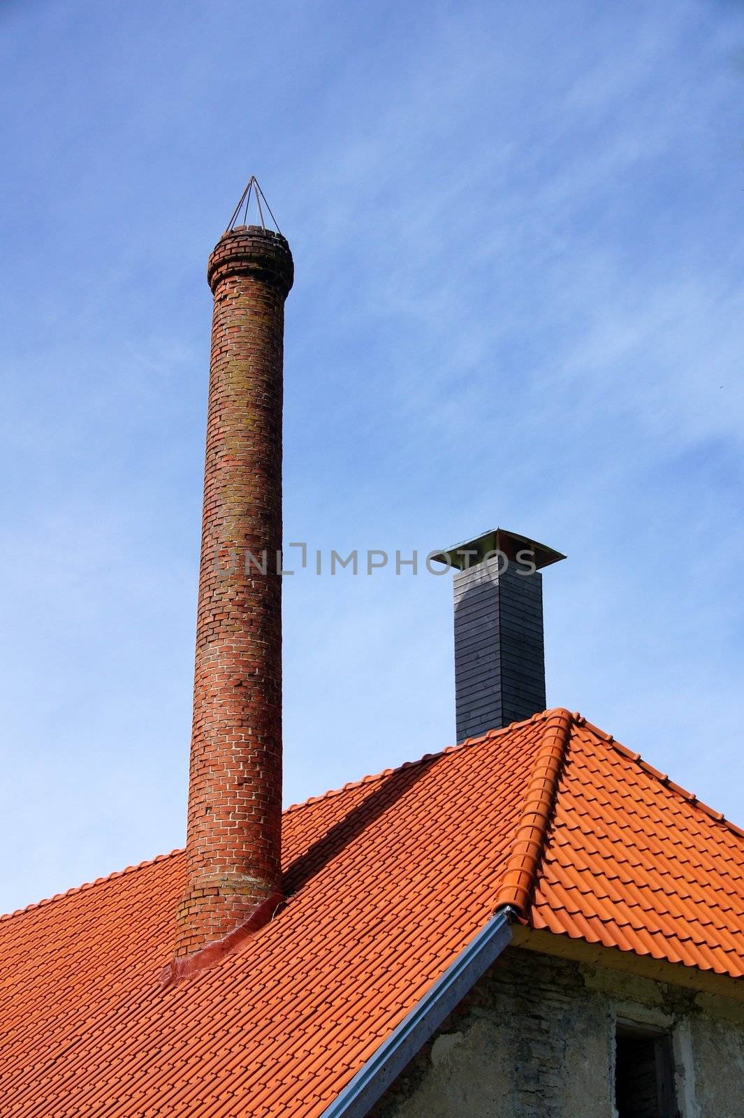 The roof and chimney with blue sky