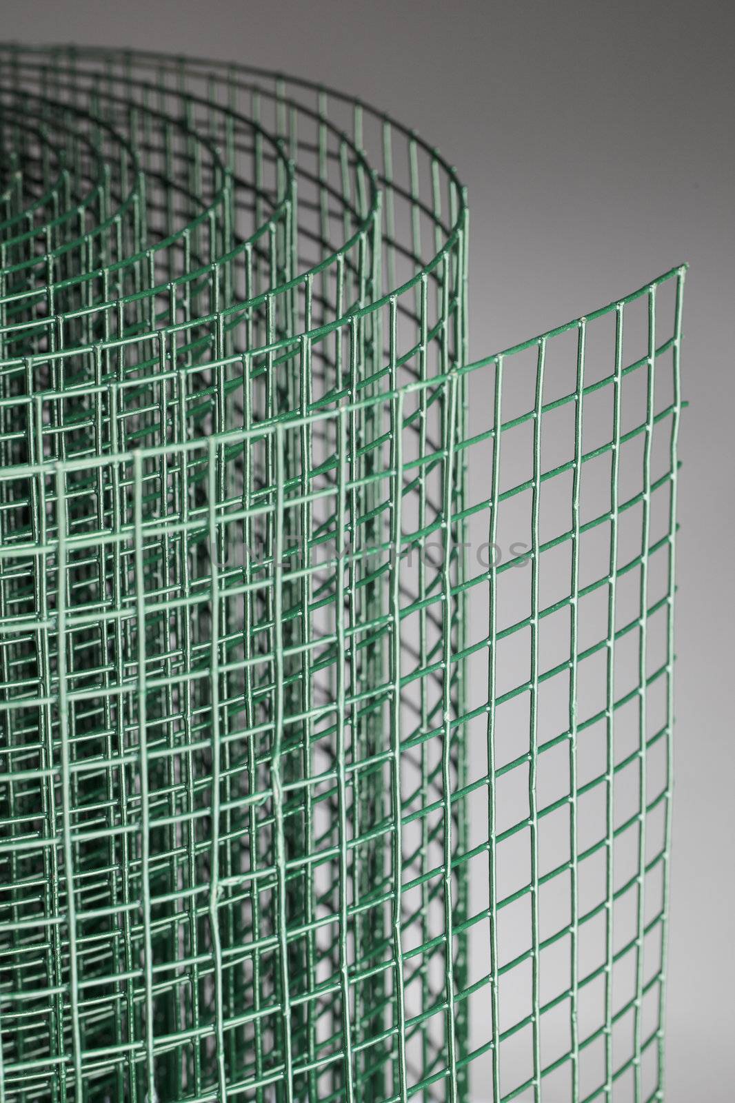 Coated green metallic wire mesh used in gardening by protecting plants from animals.