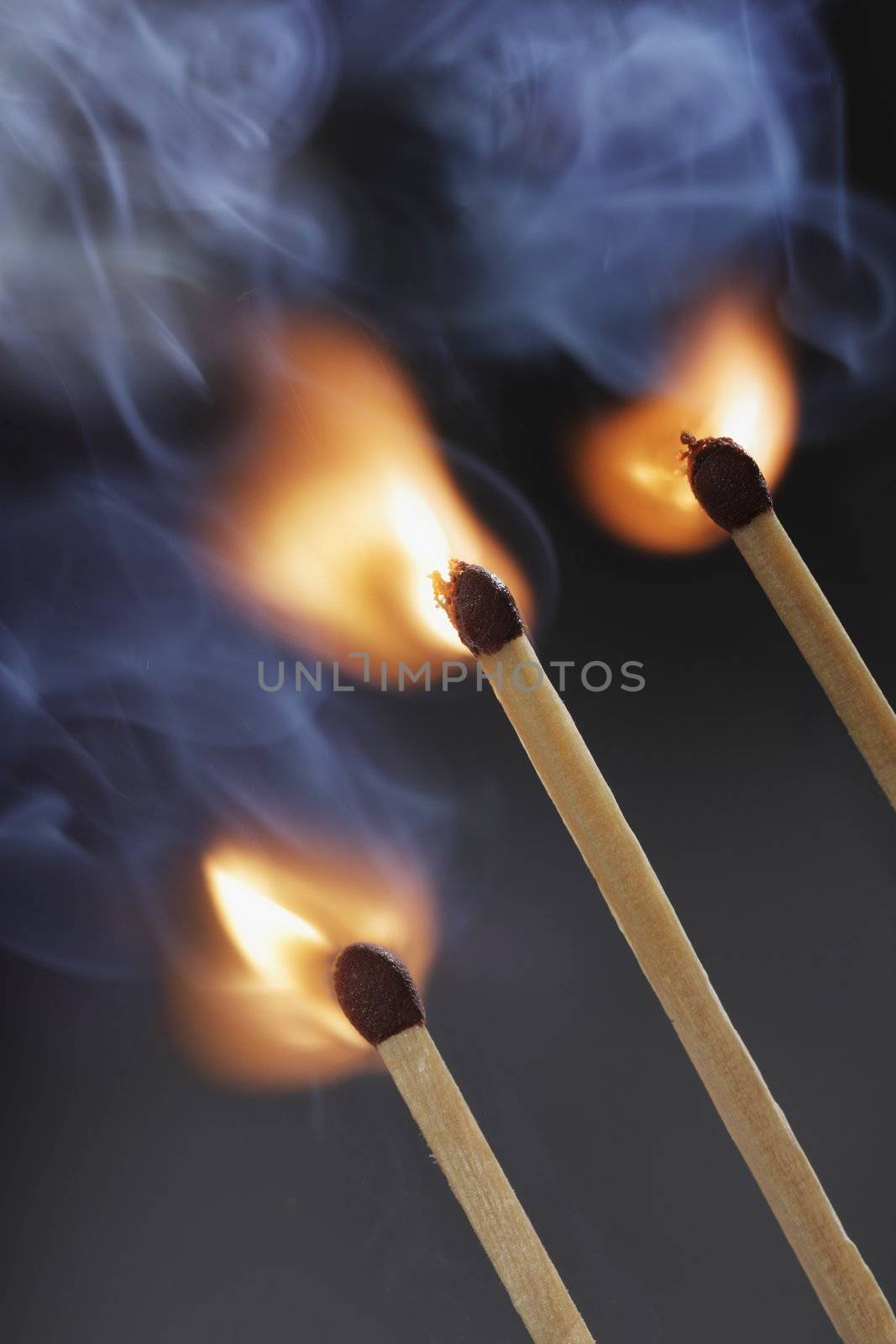 Three safety matches igniting simultaneosly