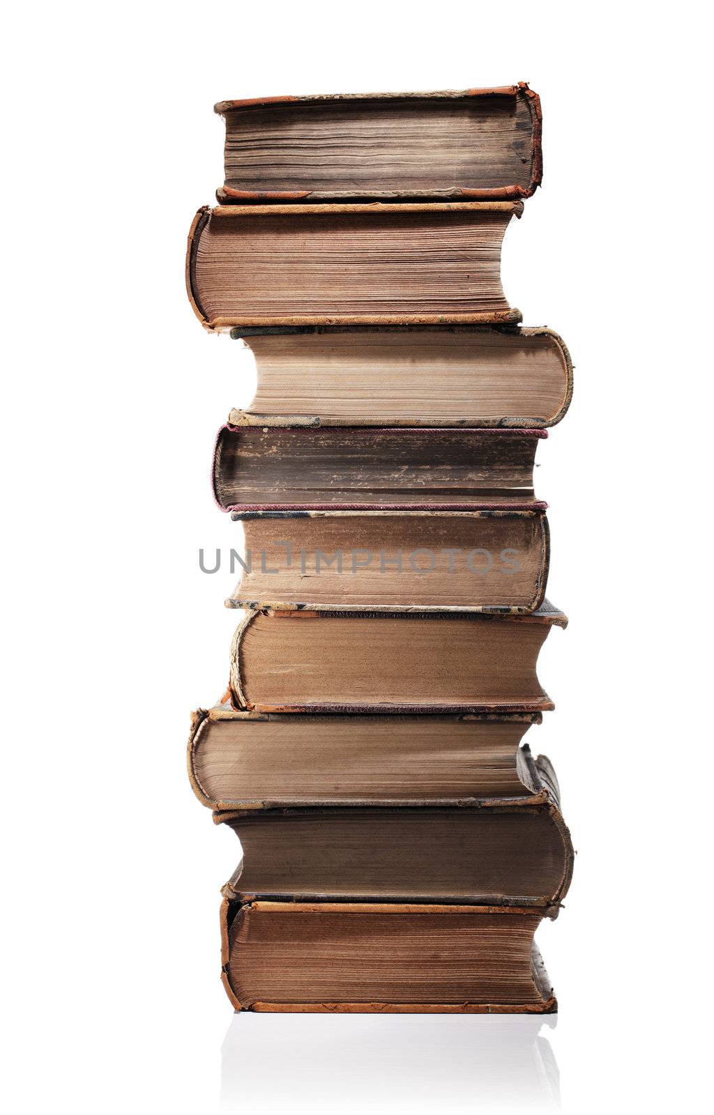 A Stack of old books isolated on white with natural reflection.