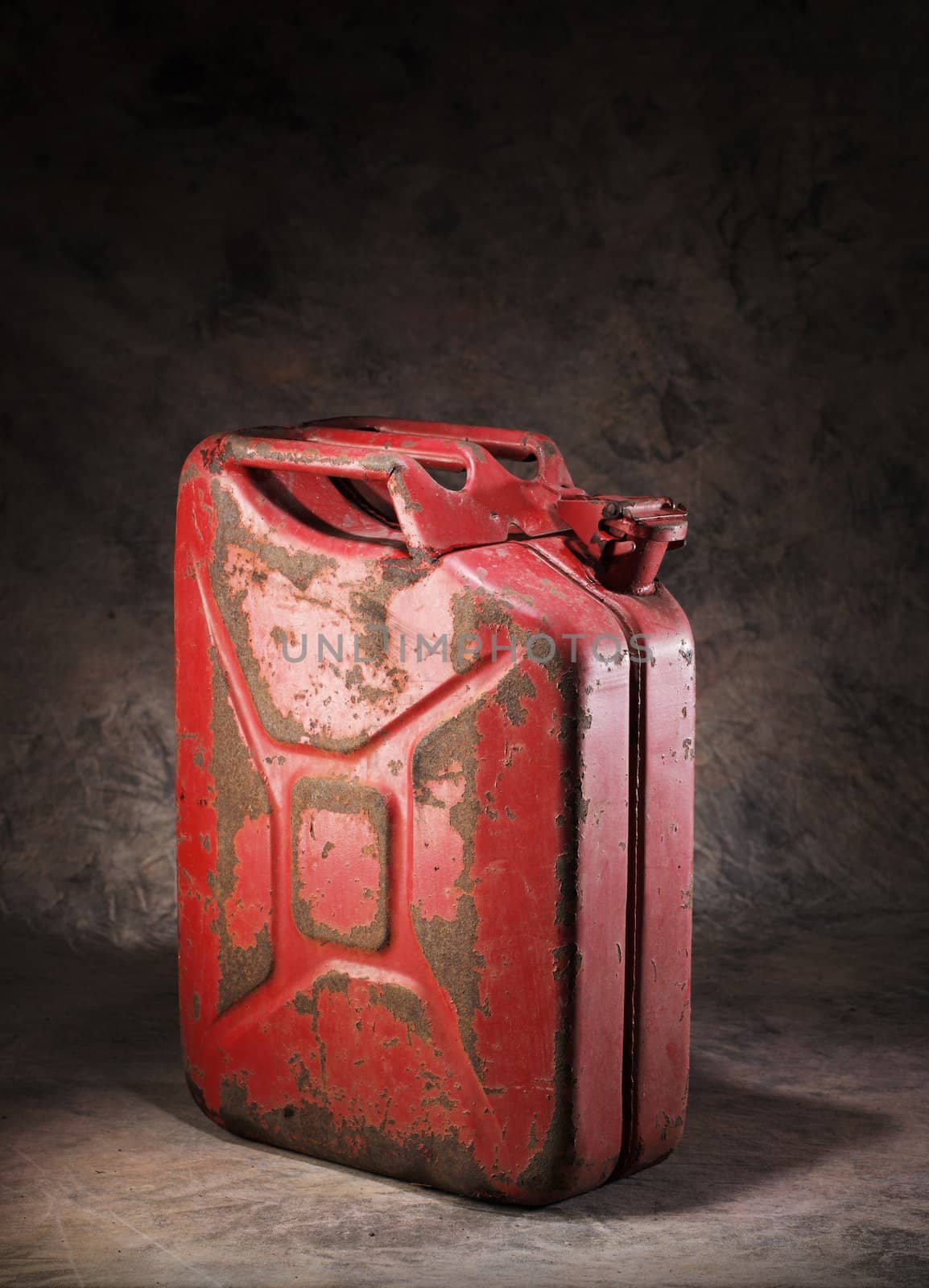 Old rusty red metallic jerry can.