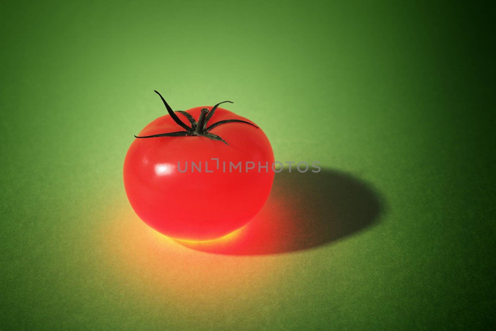 A Glowing Tomato on green background. Note that the background may appear noisy, but it's just the structure of the paper.