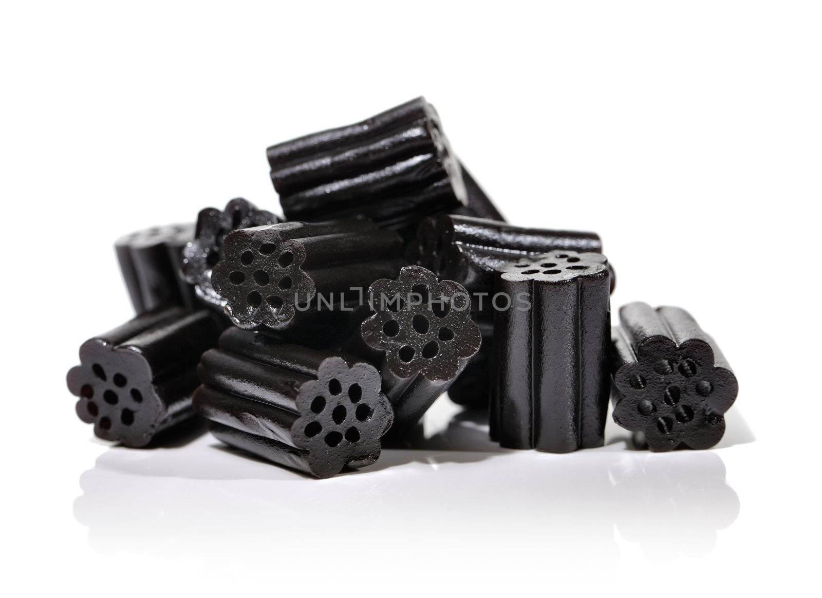 Small pile of black liquorice candies on white.