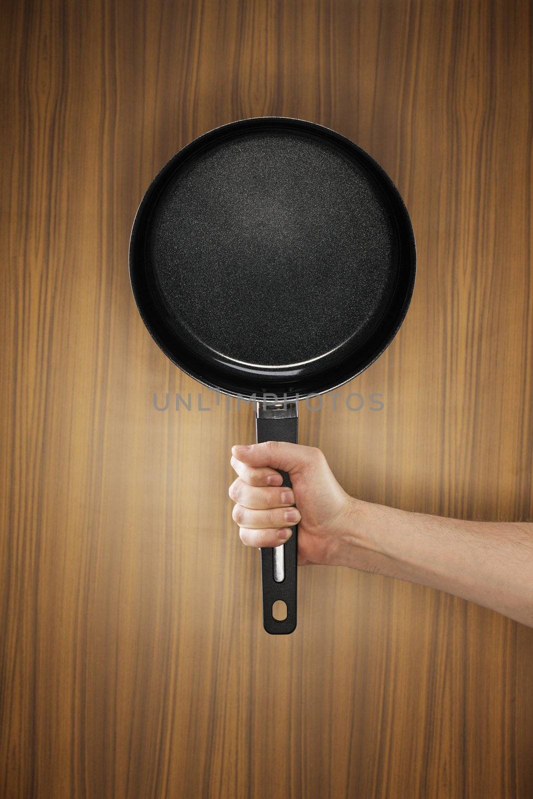 Man holding a saucepan which has a ceramic non-stick coating