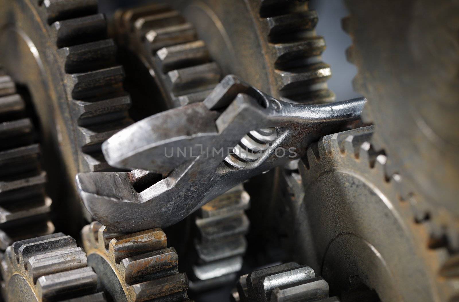 Adjustble wrench stuck between cog gear wheels.