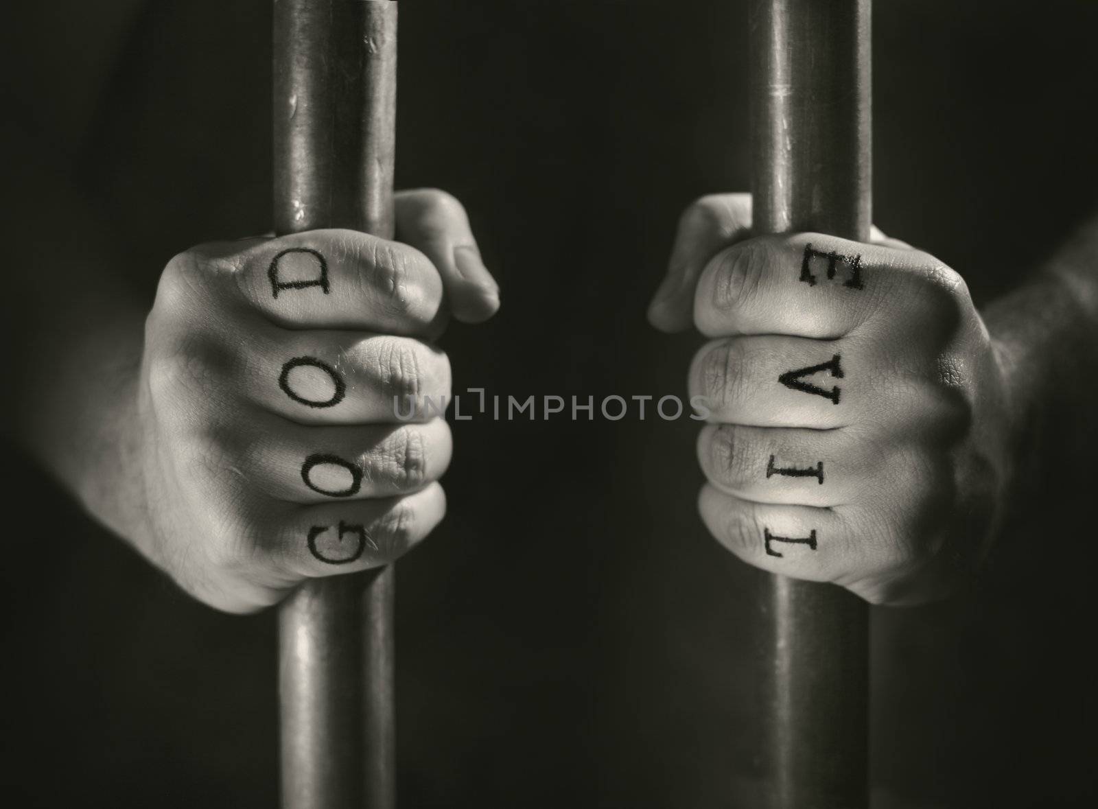 Man with (fake) Good and Evil tattoos behind prison bars.
