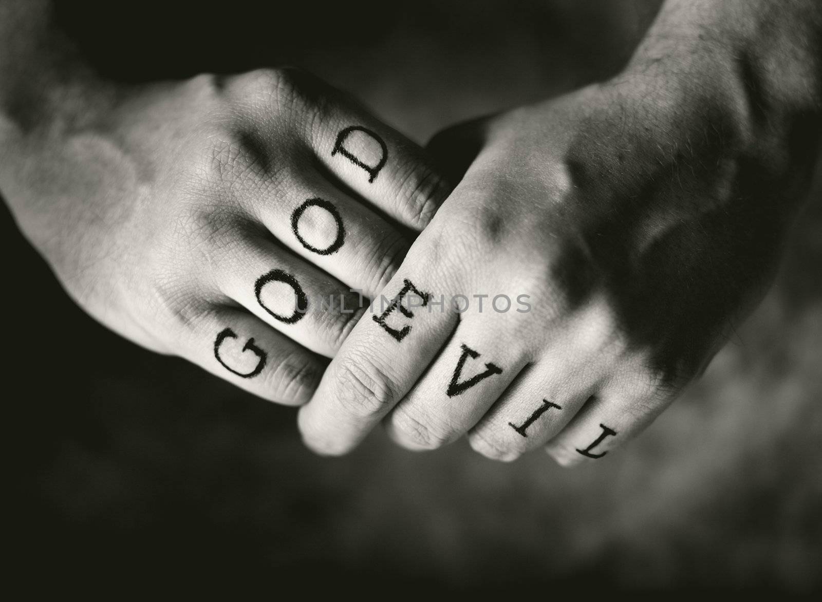 Man with "Good" and "Evil" (fake) tattoos on his fingers.