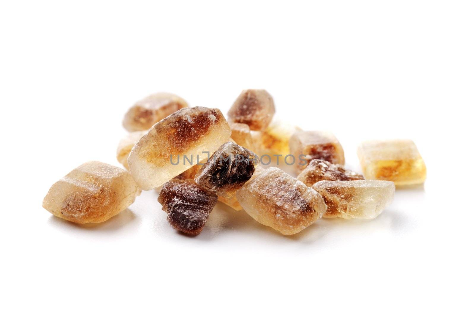 Crystals of Candi sugar / Rock sugar isolated on white with natural shadows.
