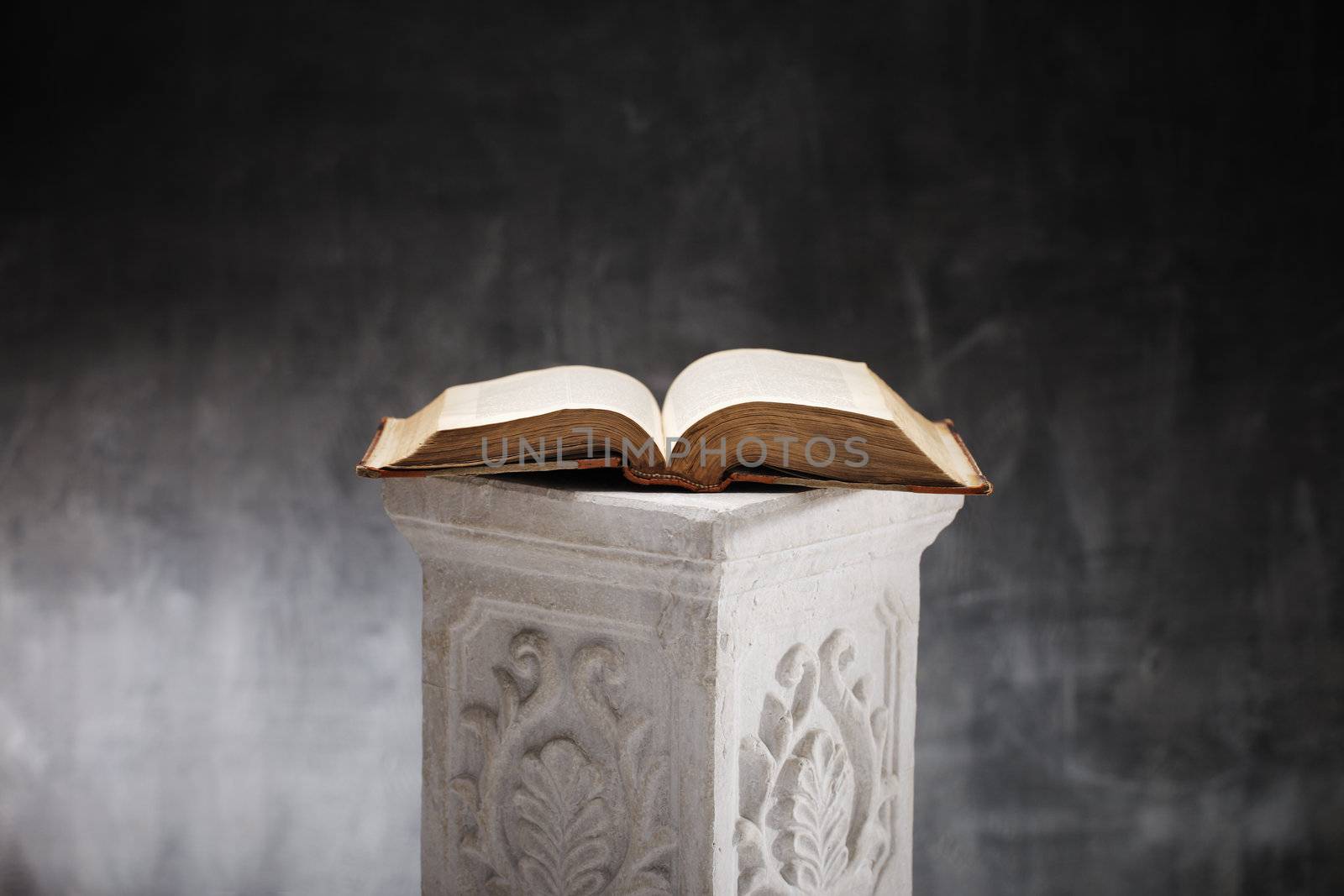 19th century antique book, opened on a decorative plaster column.