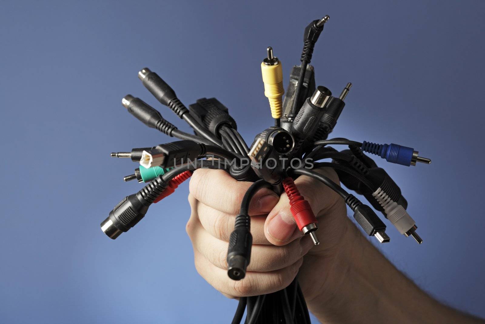FINLAND - CIRCA 2008: Man holding a bunch of different audio/video and computer cables in his hand circa 2008 in Finland