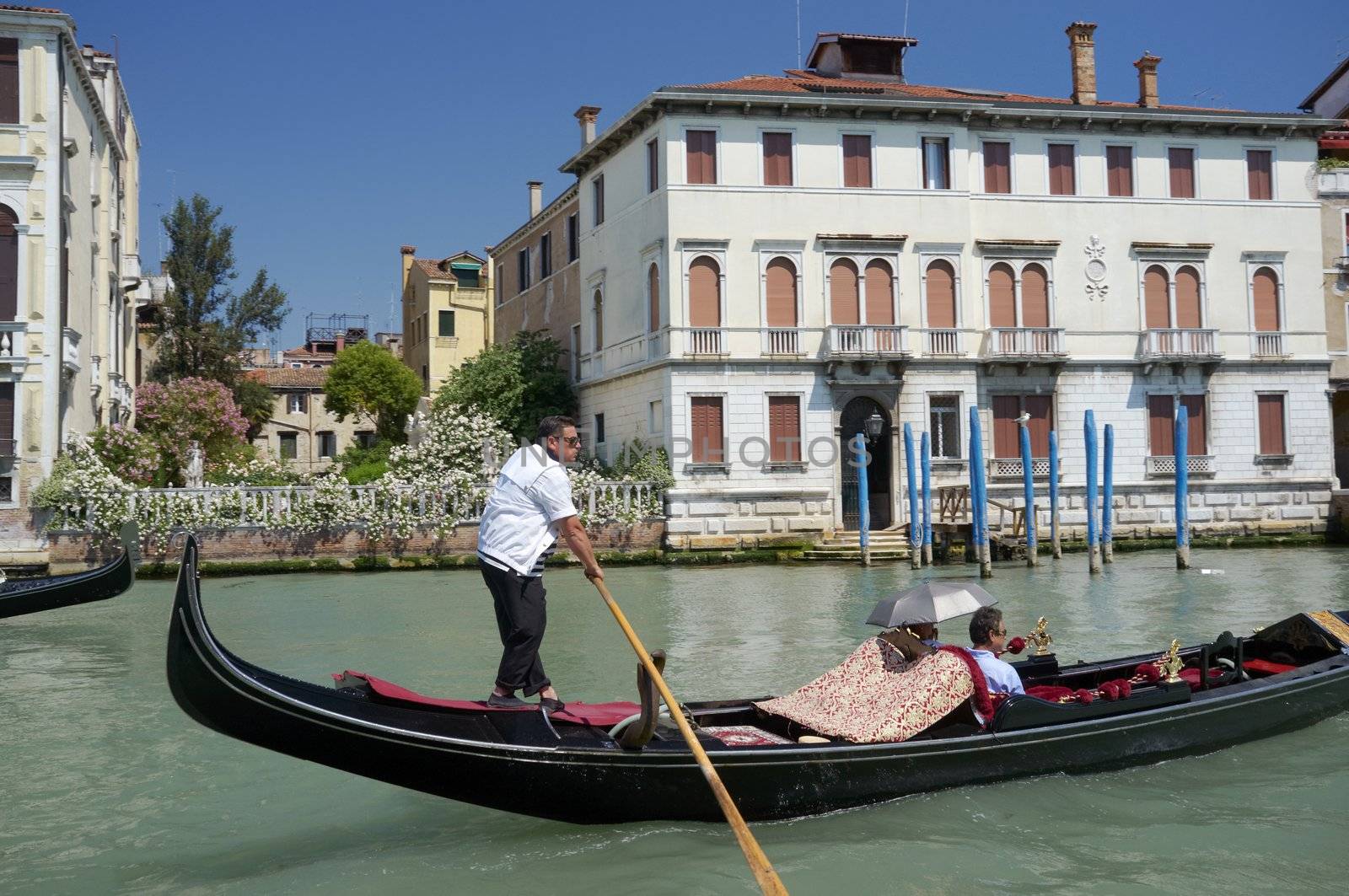 VENICE, VENETO, ITALY - CIRCA MAY 2011: Gondolier with his gondola on Grand Canal. circa May 2011 in Venice, Veneto, Italy
