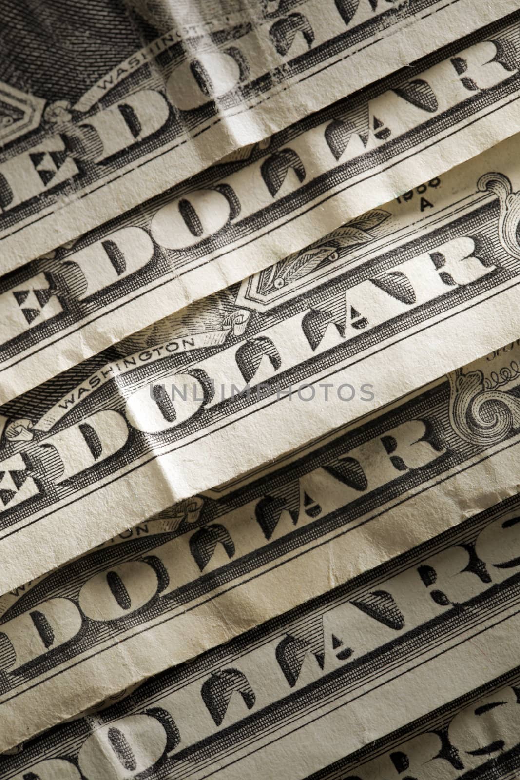 Old, worn and wrinkled dollars in closeup.