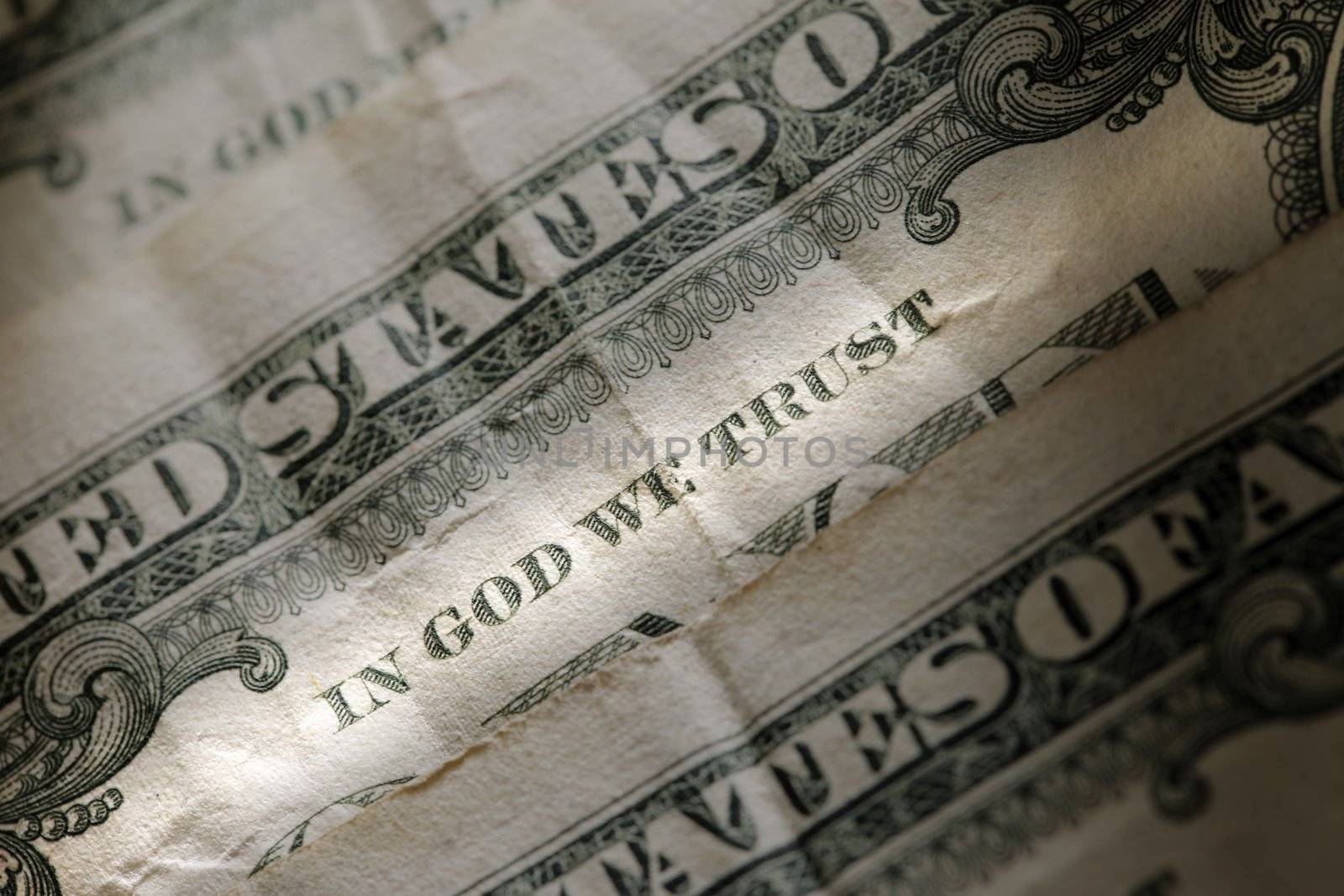 "In God We Trust" on an old american one dollar bill.