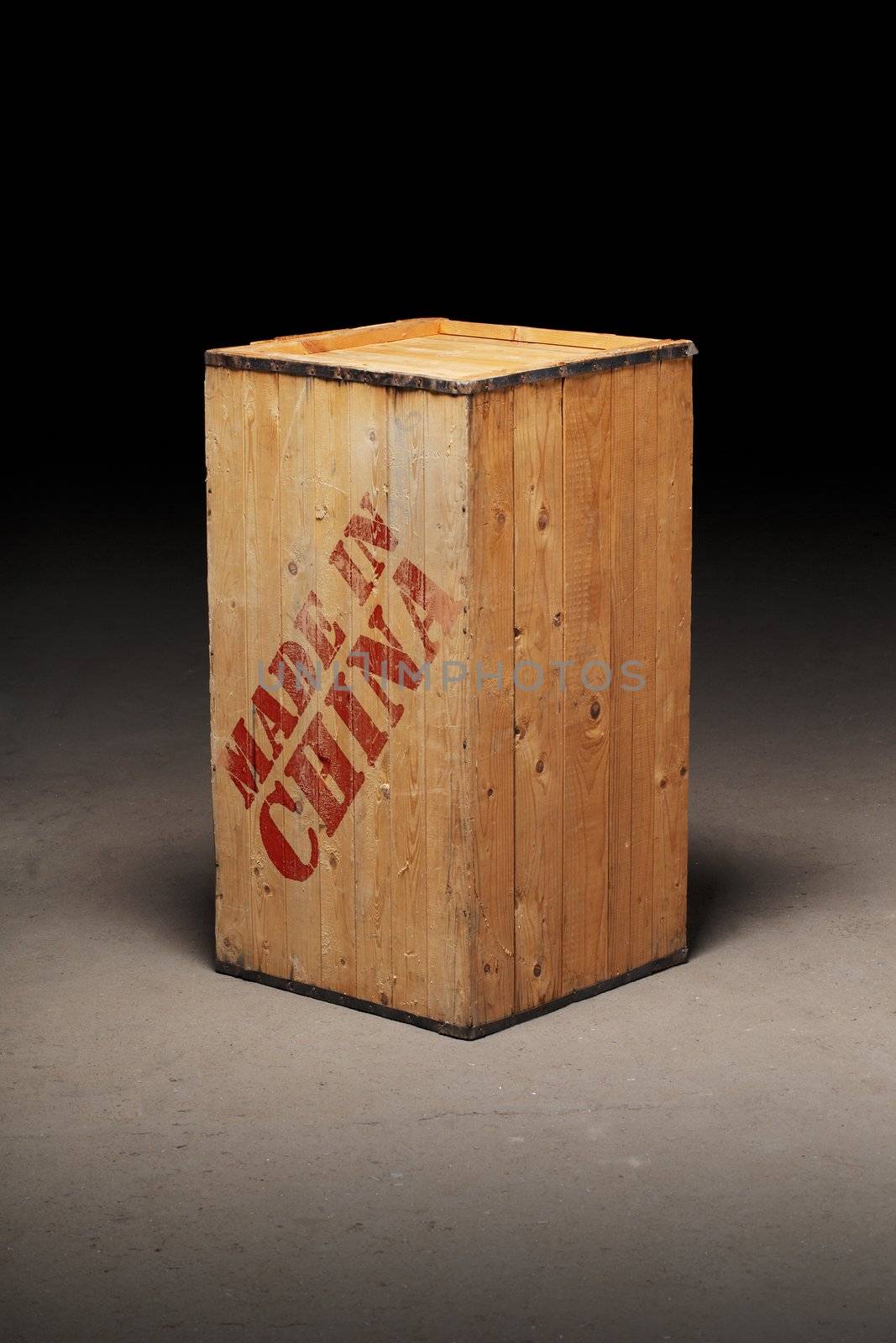 An old wooden crate with text "Made in China" on dirty concrete floor