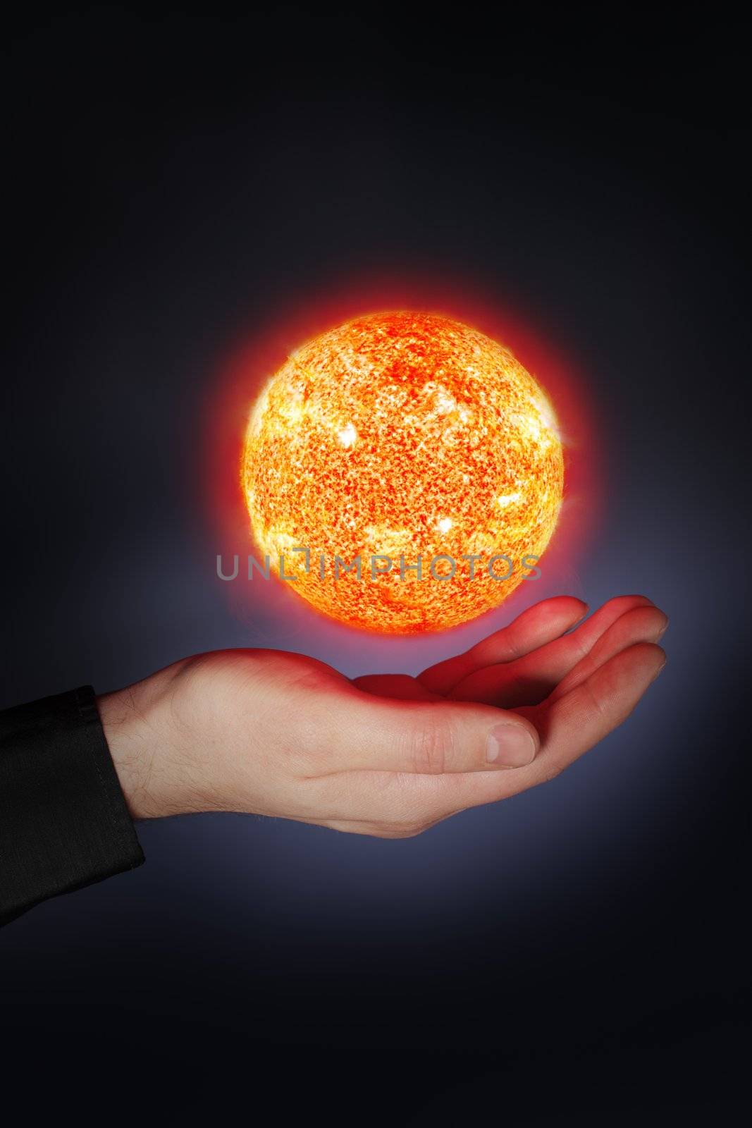 A Glowing floaing above a hand. Sun images provided by NASA.