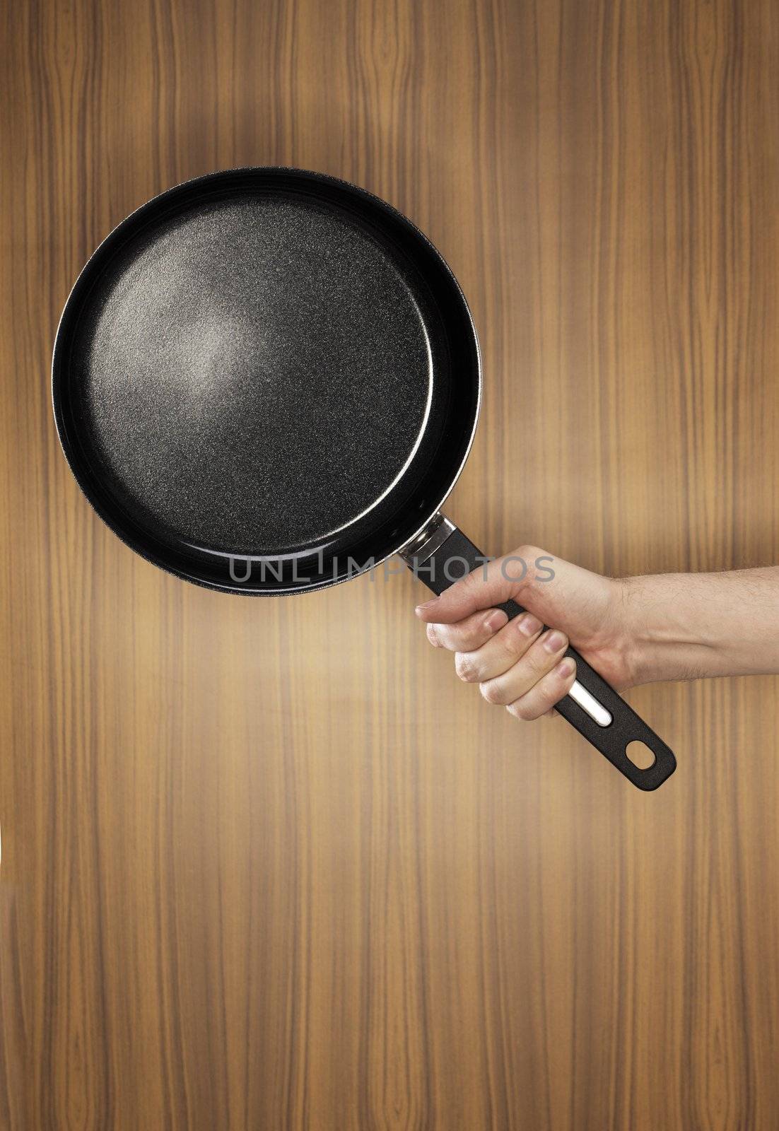 Man holding a saucepan which has a ceramic non-stick coating