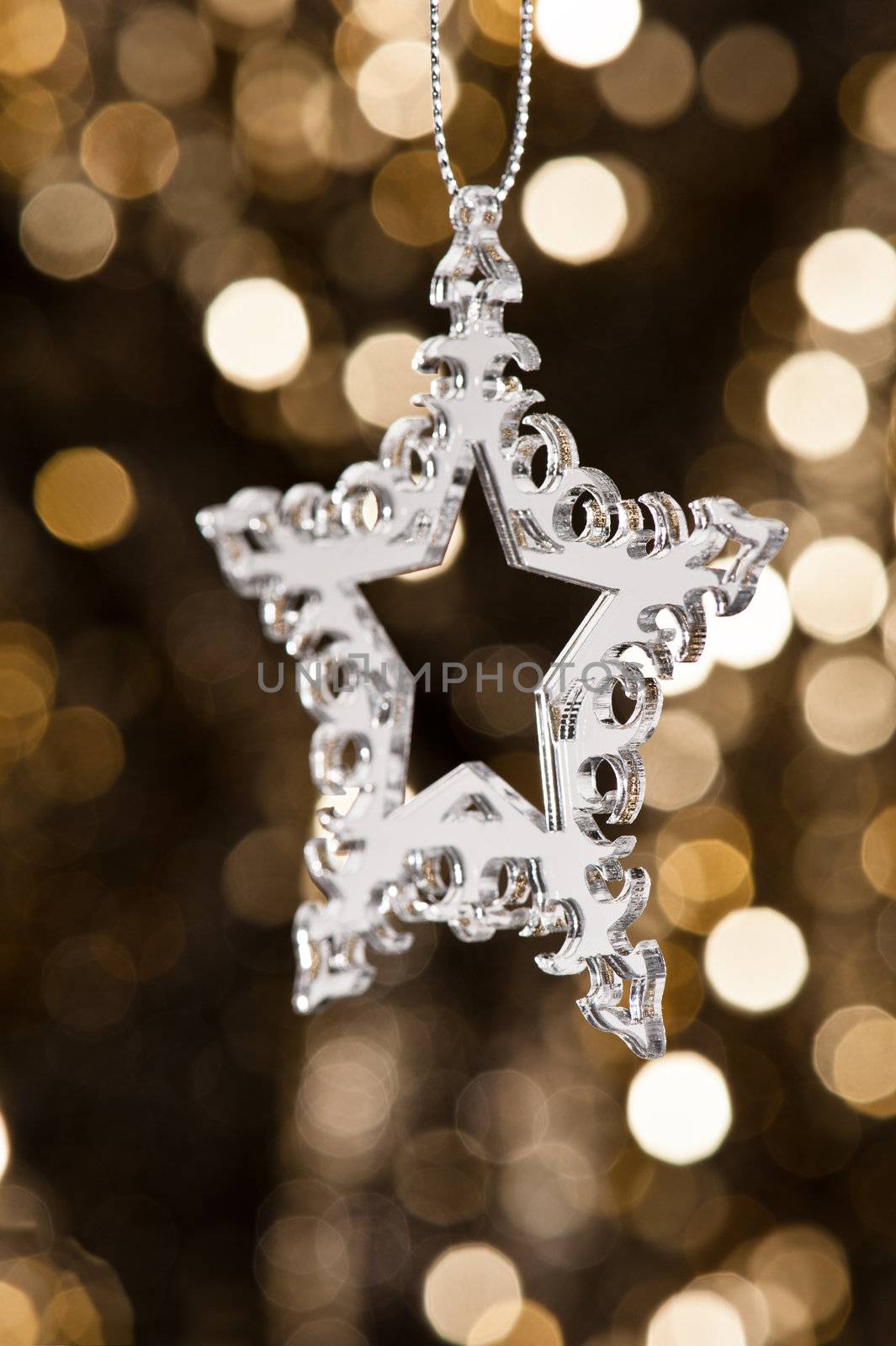 Christmas tree ornament with mirror effect over golden background