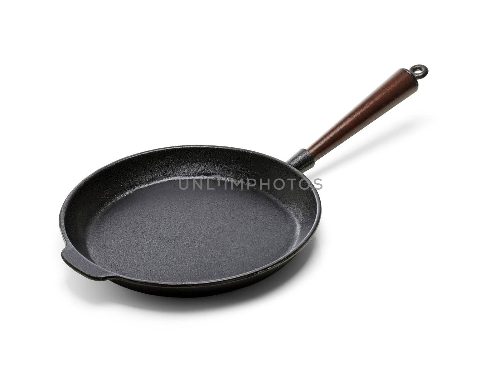 A Traditional cast iron frying pan isolated on white with natural shadows