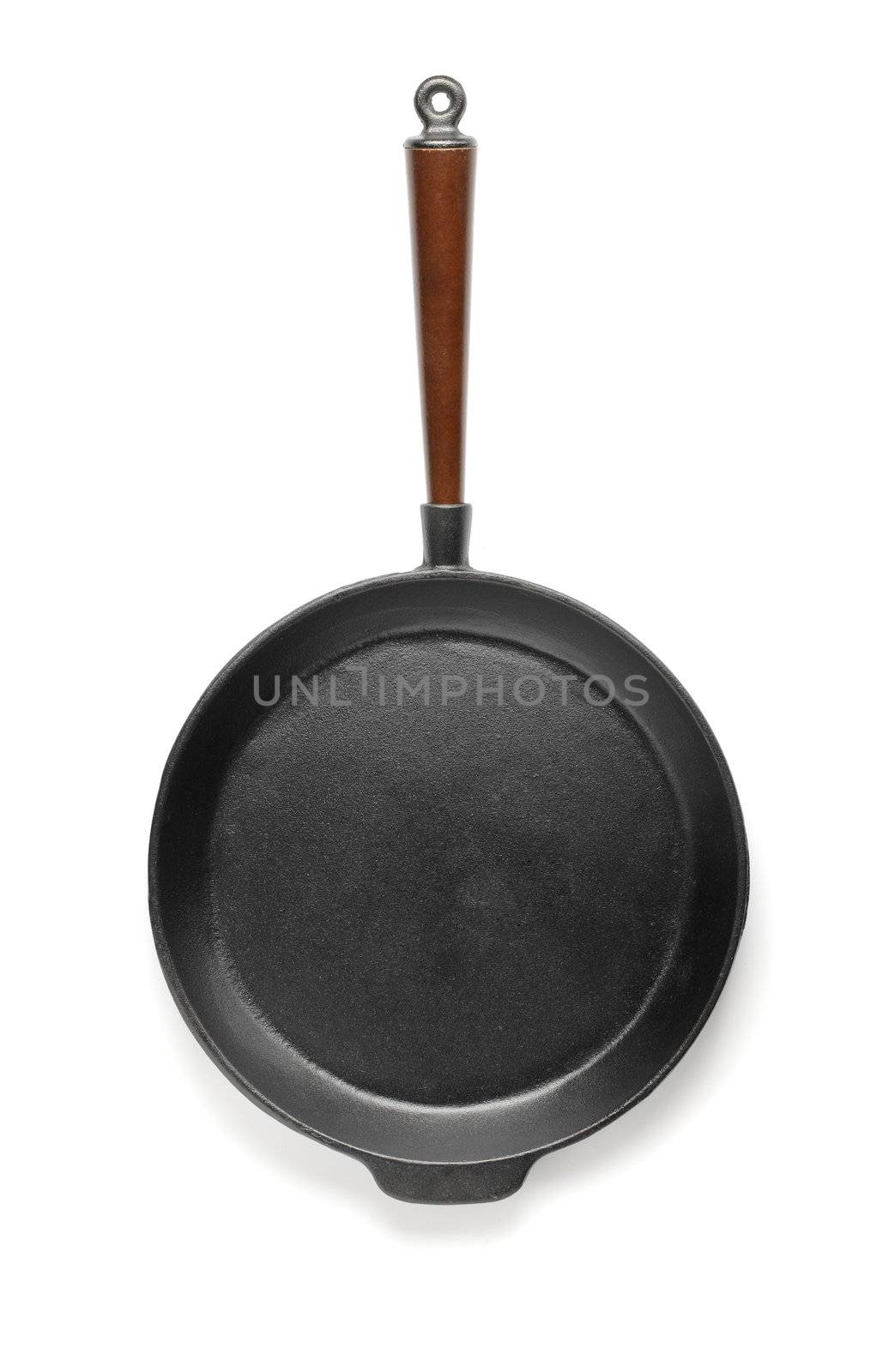 Old fashioned cast iron frying pan isolated on white with natural shadows.