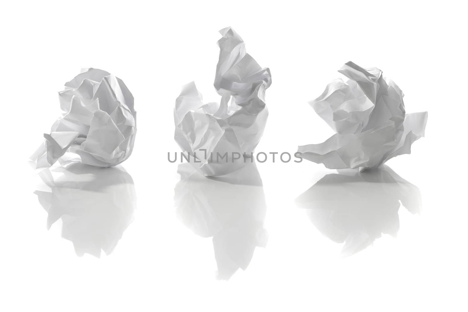 Crumpled white papers with reflections