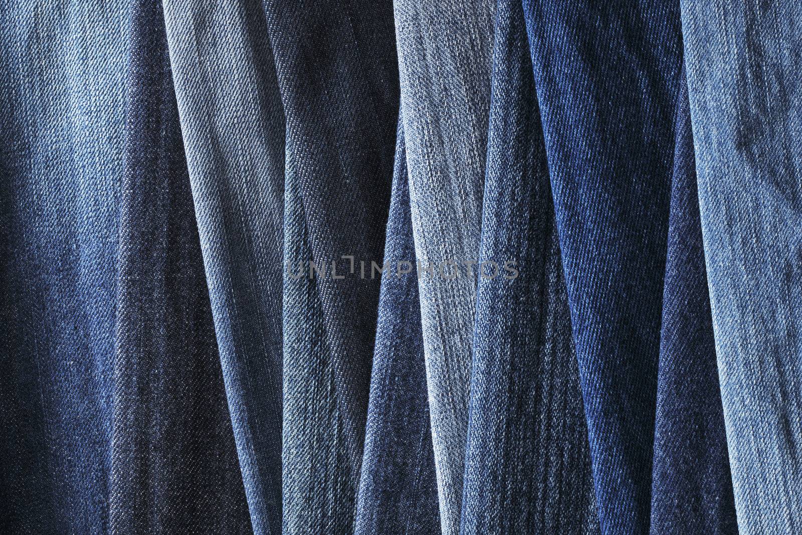 Background image of different blue denim jeans fabrics