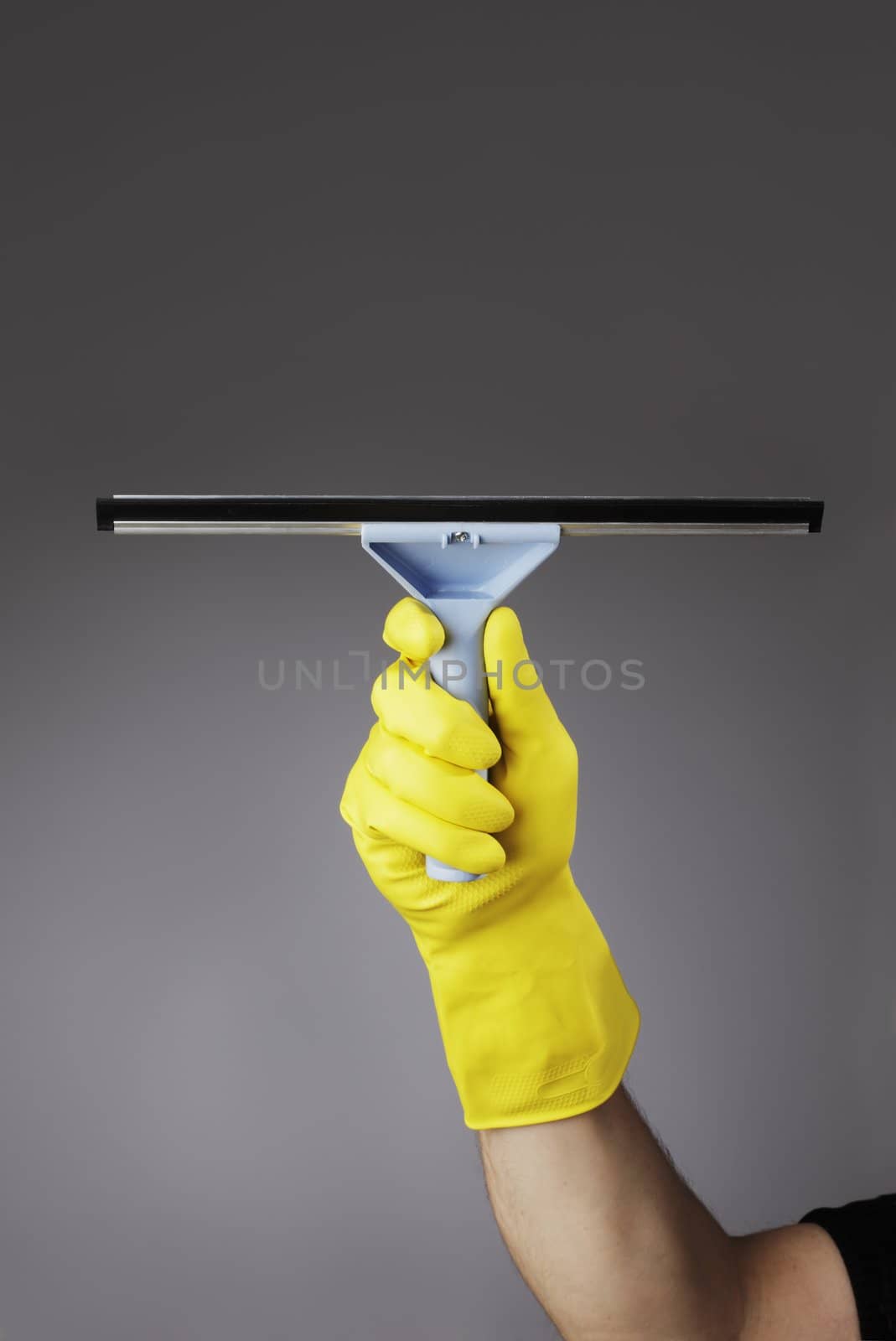 A gloved hand holding a squeegee