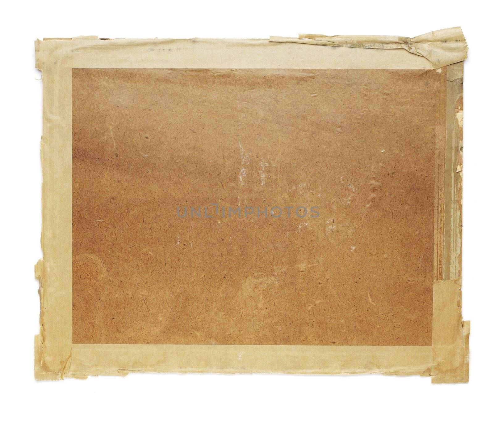 Old cardboard taken from an 100 year old photo frame. Isolated on white with natural shadows.