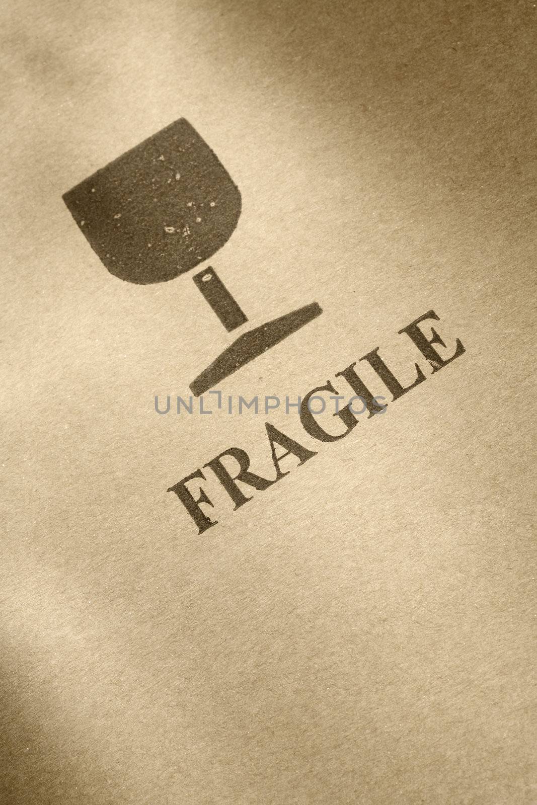 "Fragile" symbol printed on brown cardboard
