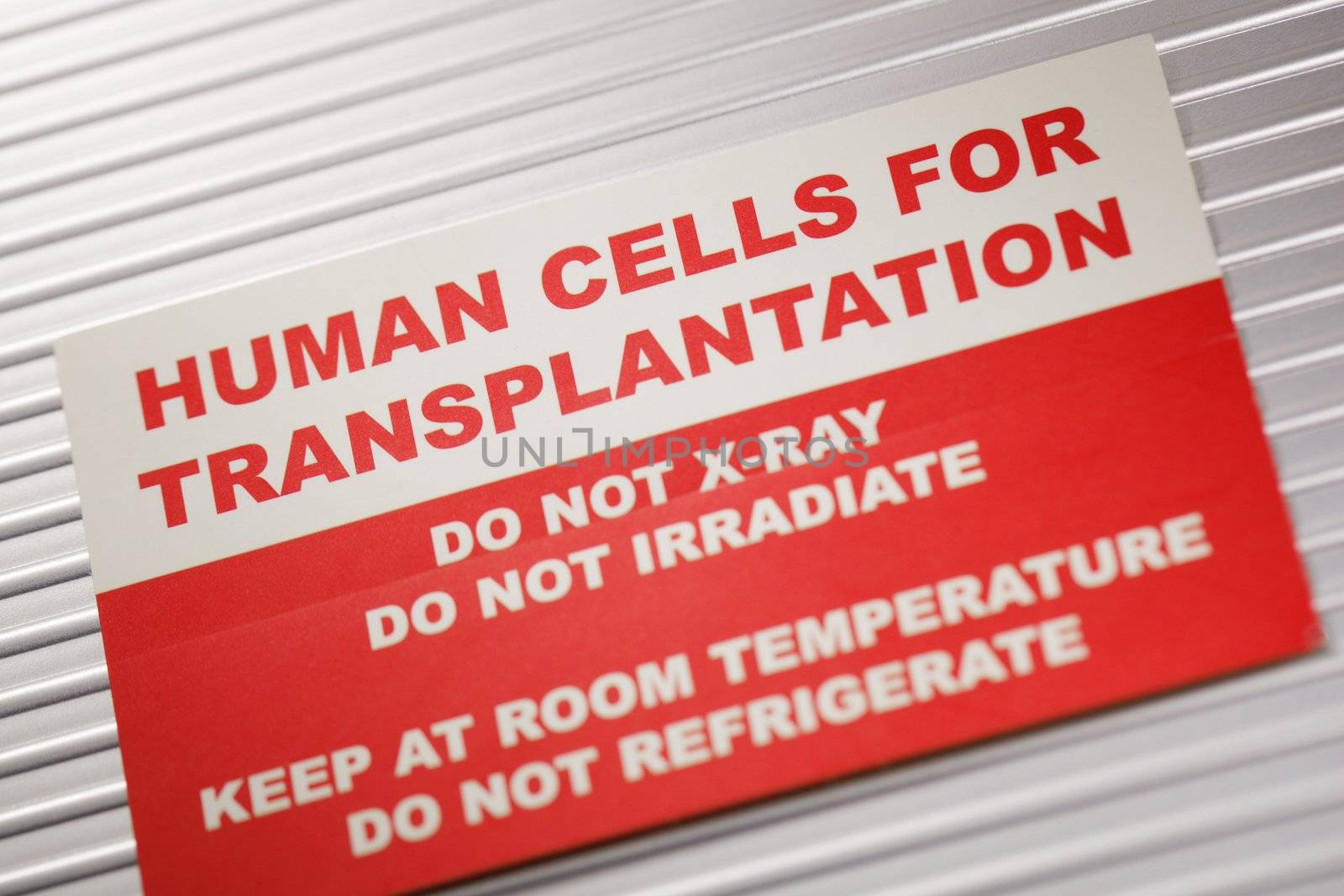 Human Cells for Transplantation information sticker. Short depth-of-field.