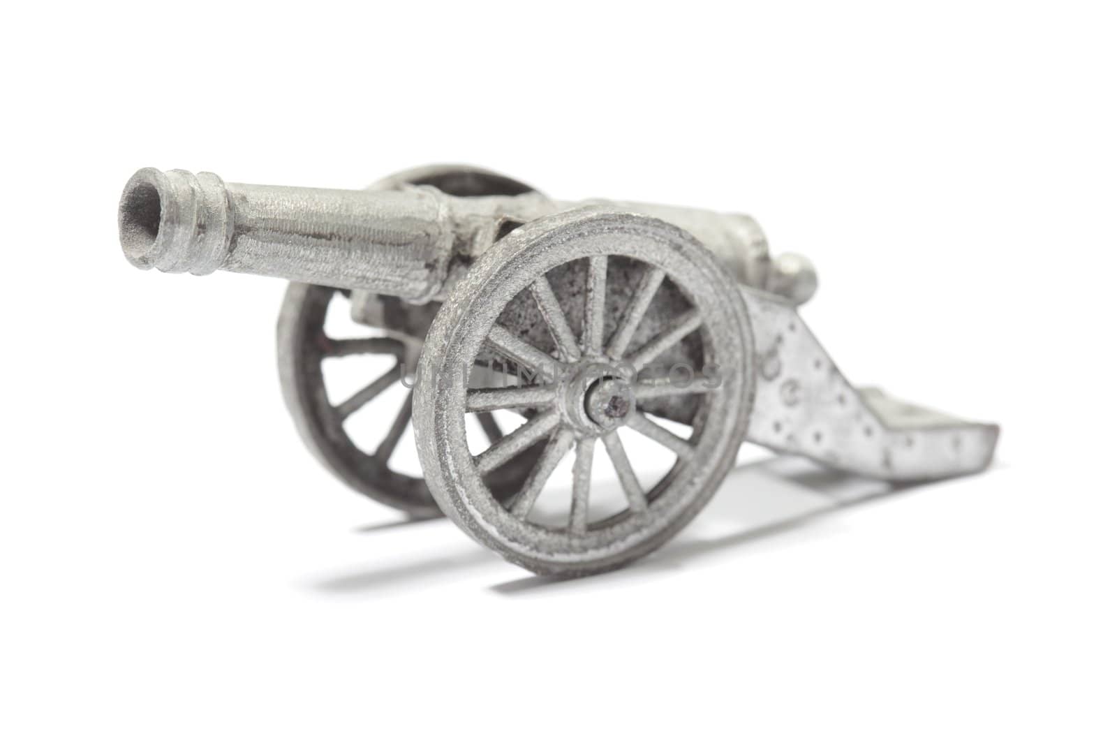 Old metallic toy cannon isolated on white