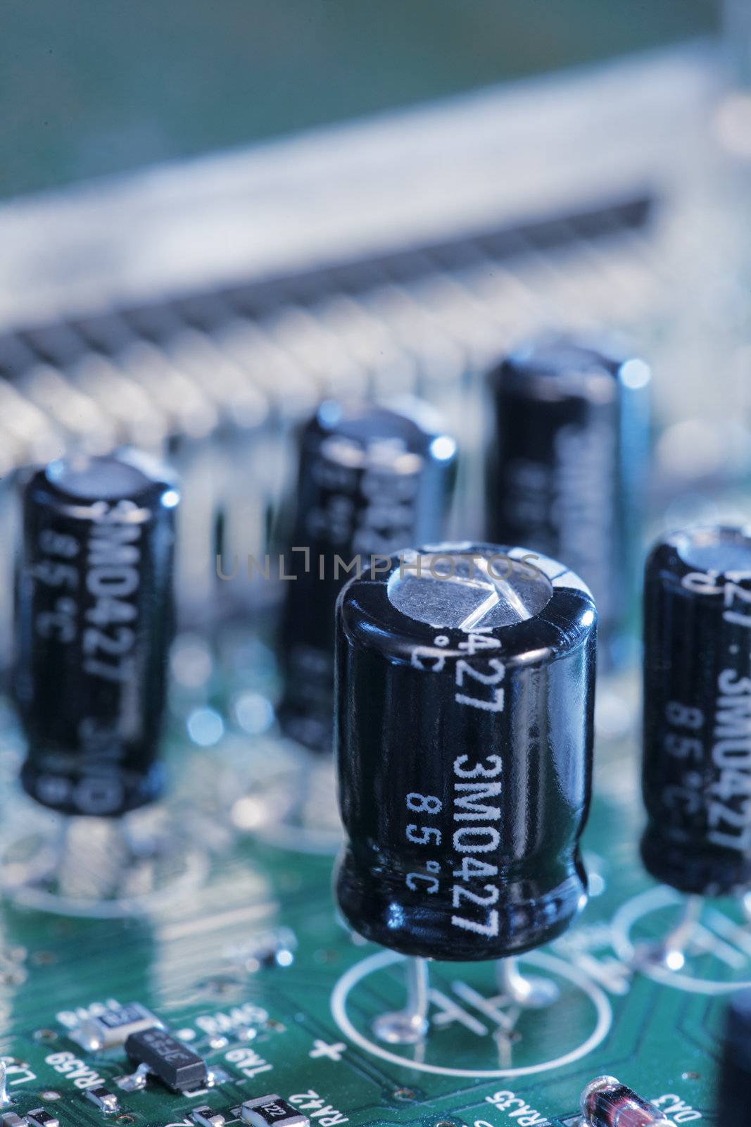 Capacitors on a circuit board. The text on the components is NOT manufacturer's logo.
