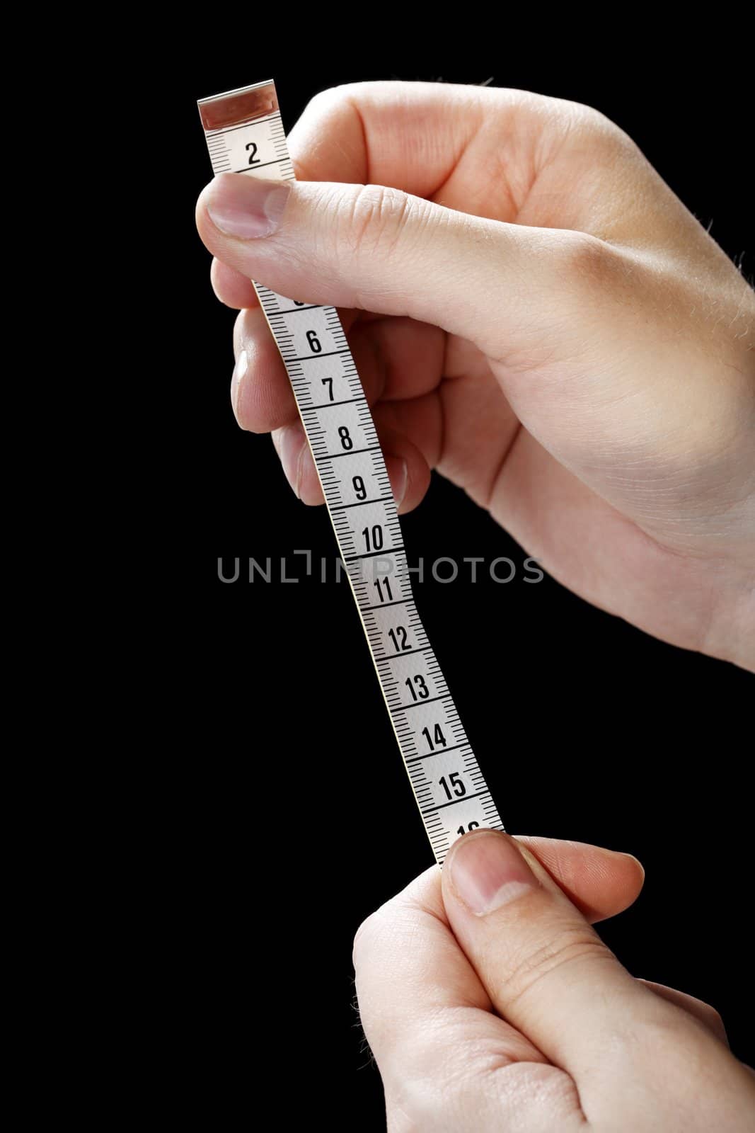 Hands holding a metric white tape measure