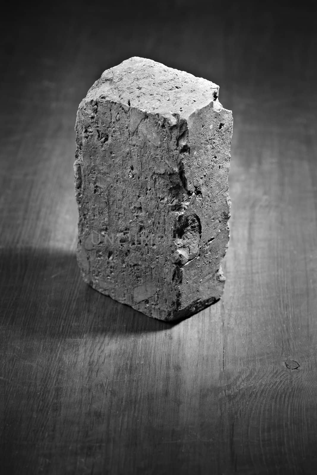 Black and white image of an old and worn brick