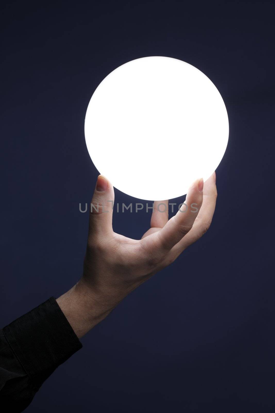Man holding an illuminated sphere