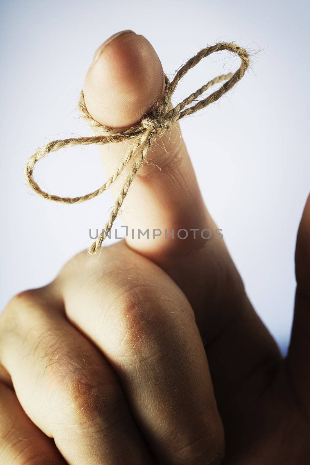 A piece of string tied around index finger