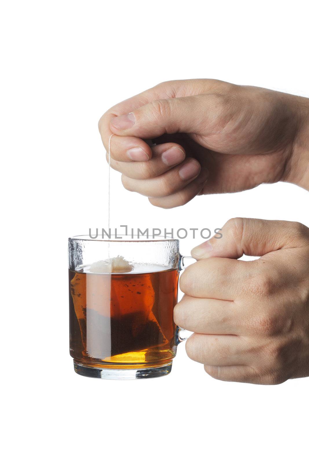 Teabag in a transparent glass tea mug with hot water