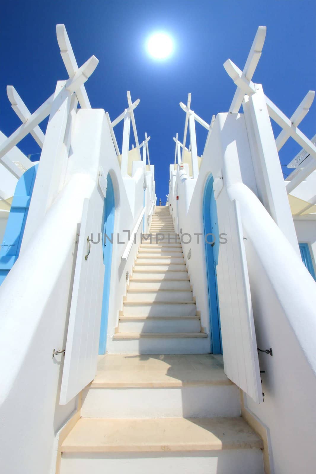 Beautiful colorful stairs with two walls going to the sun in deep blue sky