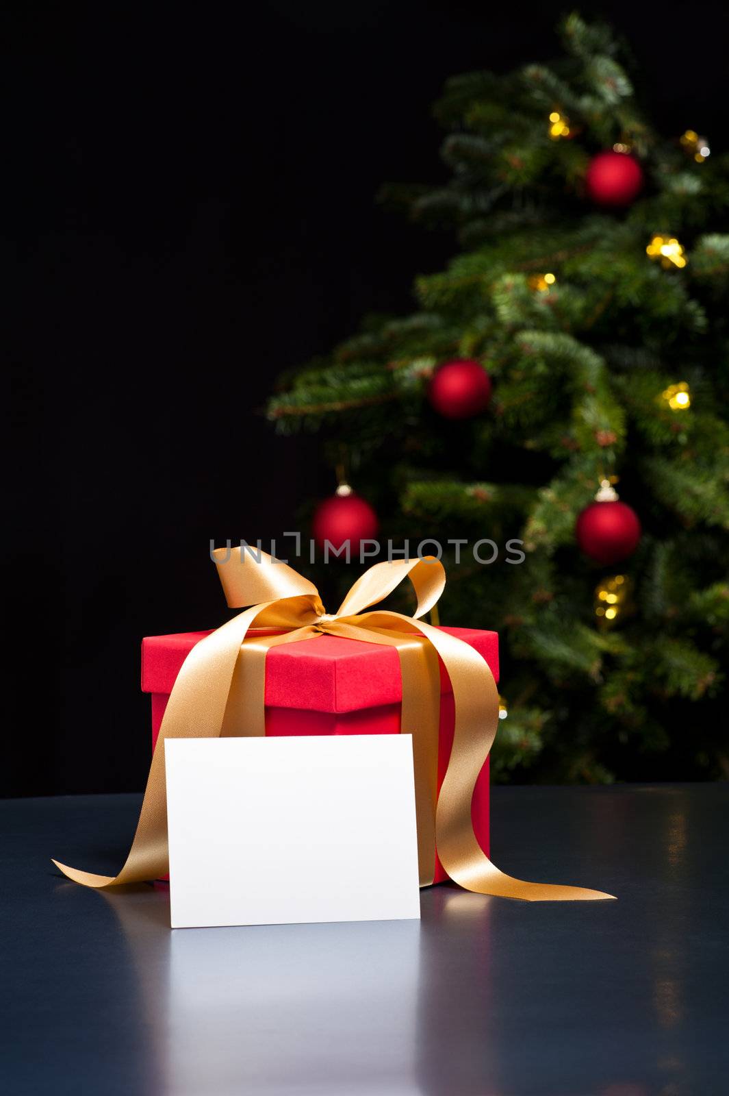 Christmas present with white card in an elegant Christmas setting