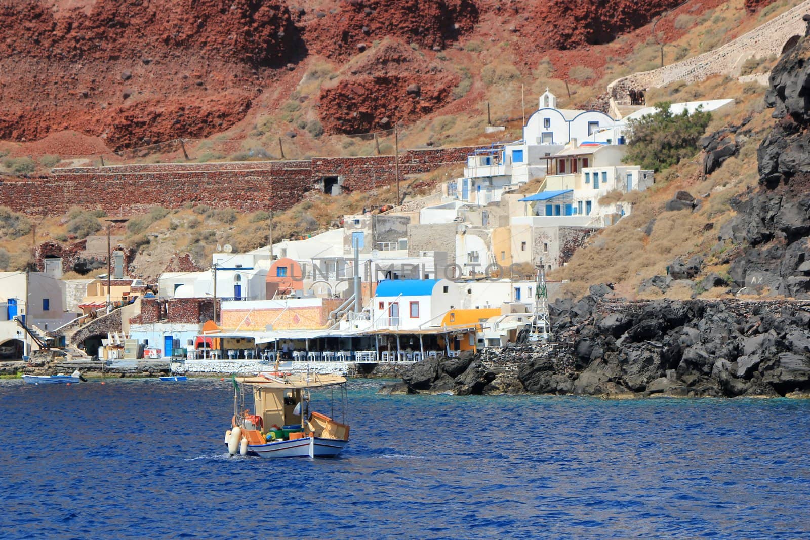 View on Thirassia harbor with a boat, Santorini, Greece