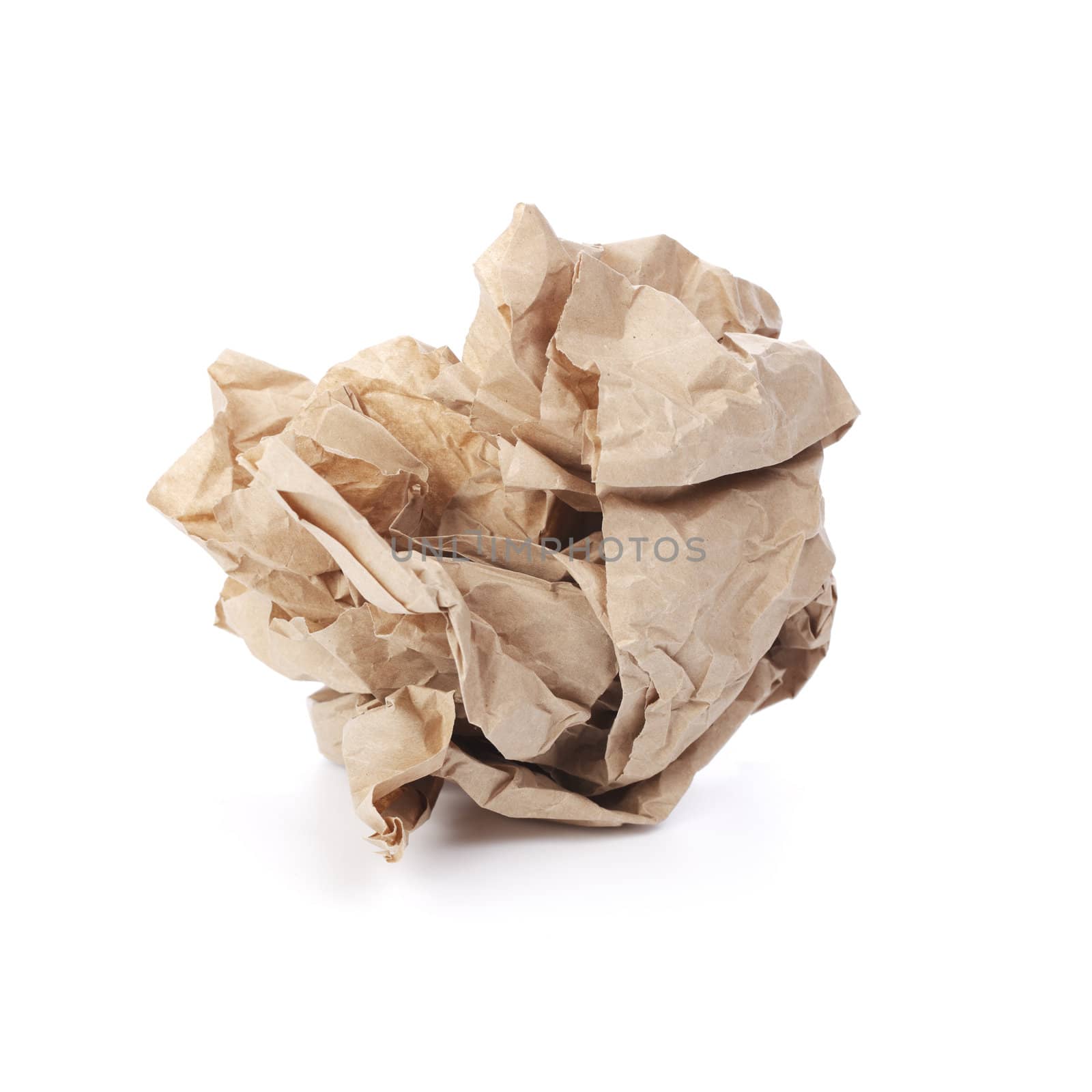 Crumpled brown paper isolated on white with natural shadows