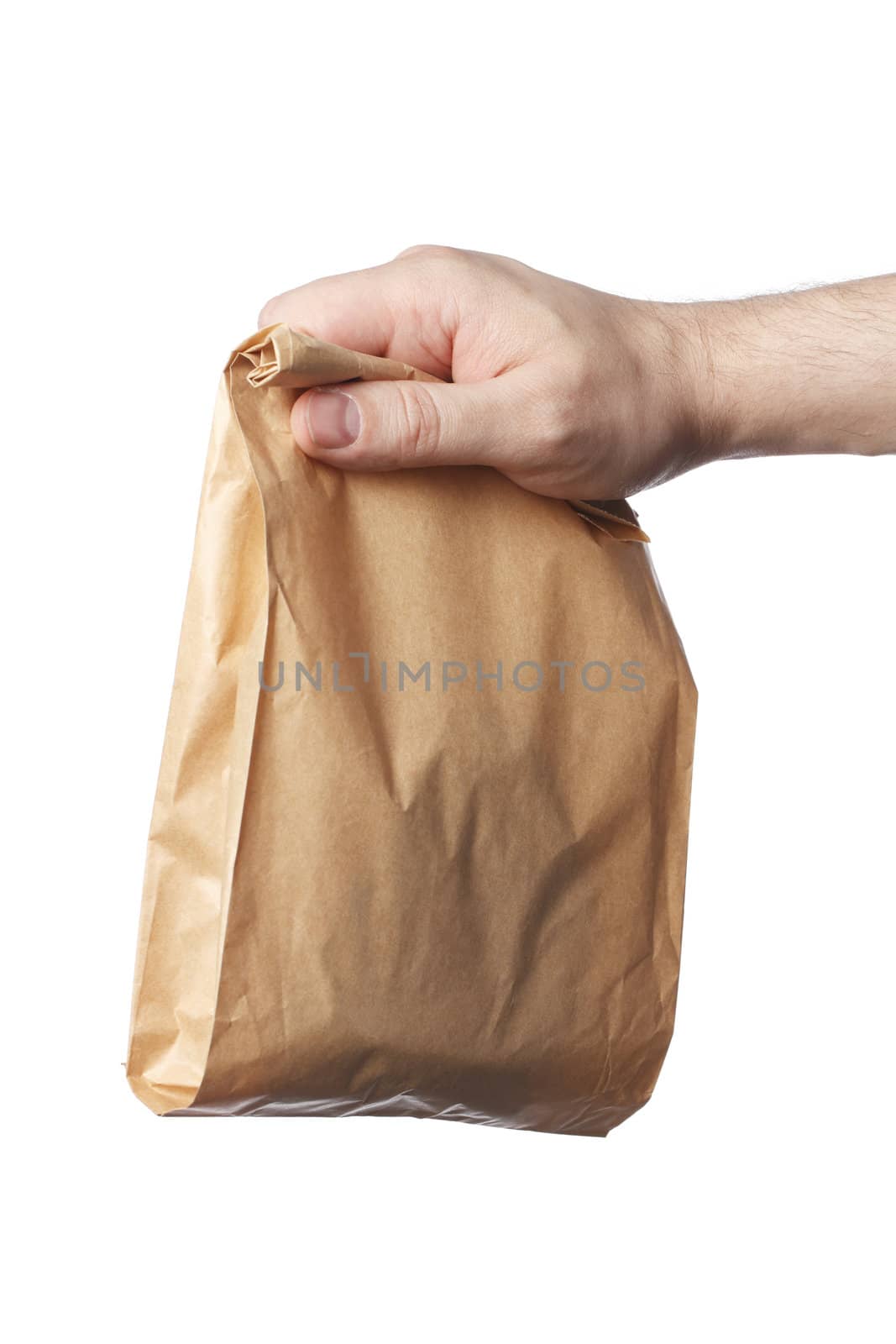 Man holding a brown paper bag with contents in his hand.