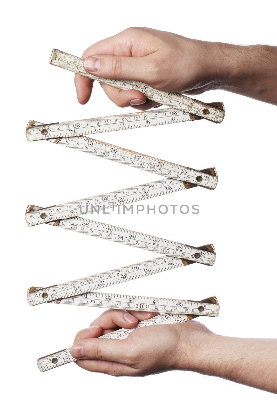 Man holding an old folding carpenter's ruler