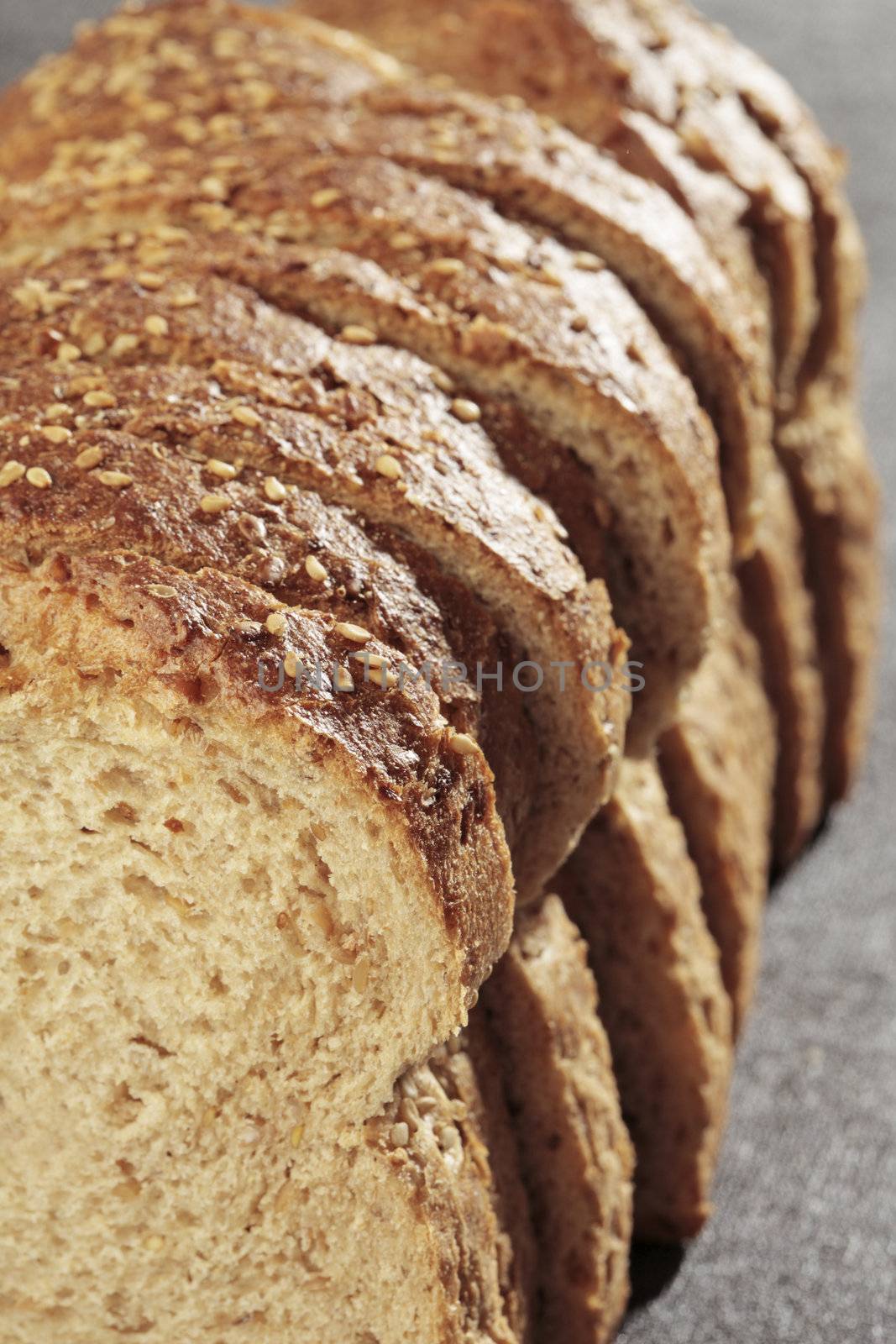 Sliced wheat bread on grey