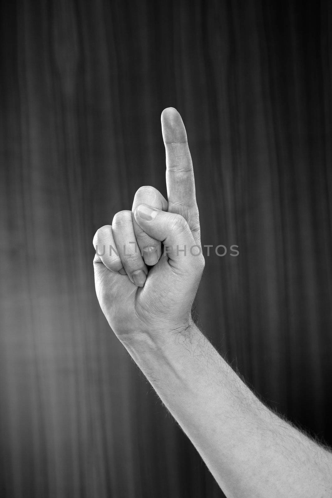 Black and white image of man pointing with his index finger