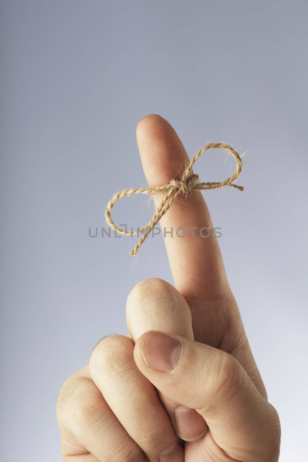 A Manila hemp thread bound around an index finger