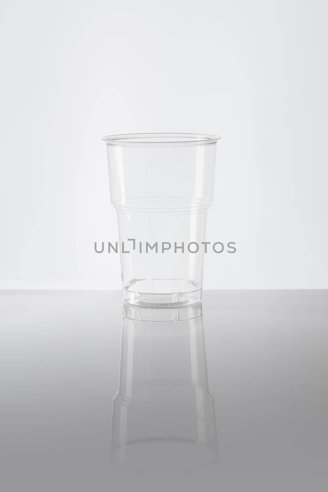 Empty disposable plastic cup made of clear plastic