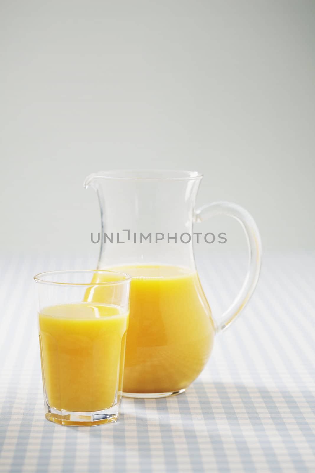 Orange juice in a glass and in a jug