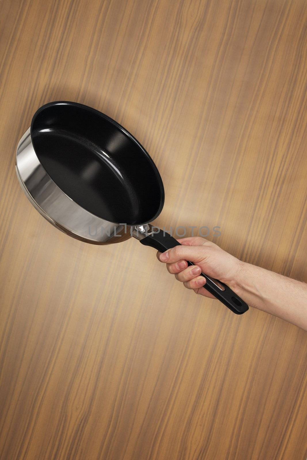 Man holding a saute pan.