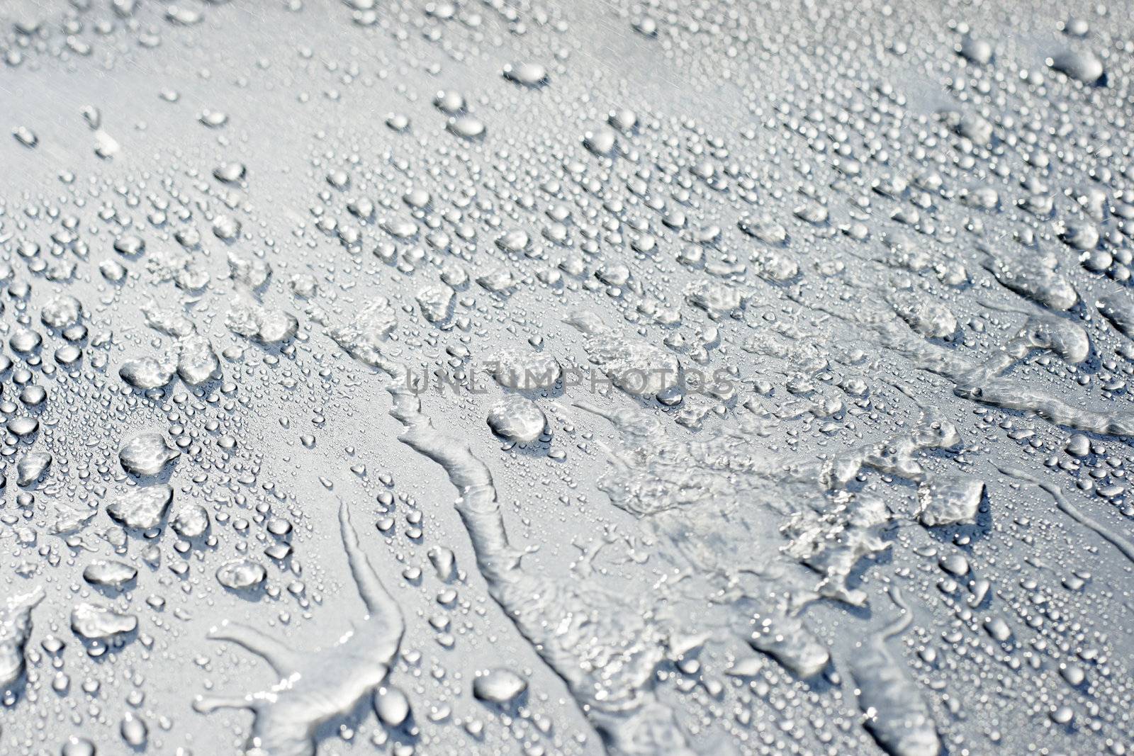 Water spray and droplets on a car. Short depth of field